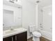 A clean bathroom featuring a single sink vanity, a toilet, and a shower and tub combo at 3008 Thornton Dr, Kissimmee, FL 34741