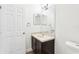 Bathroom with vanity, framed mirror, and a white door at 3008 Thornton Dr, Kissimmee, FL 34741