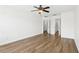 Large bedroom with new floors and ceiling fan at 3008 Thornton Dr, Kissimmee, FL 34741