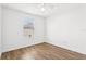 A simple bedroom with wood-look floors and one window at 3008 Thornton Dr, Kissimmee, FL 34741
