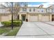 Townhome featuring attached garages, lush landscaping, and a welcoming front entrance at 3008 Thornton Dr, Kissimmee, FL 34741