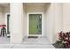 Inviting covered front porch featuring decorative plants and a welcoming green door at 3008 Thornton Dr, Kissimmee, FL 34741