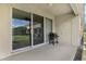 Outdoor patio featuring sliding glass doors, a grill, and a convenient storage closet at 3008 Thornton Dr, Kissimmee, FL 34741