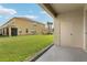 View from the patio of a lush green lawn and nearby buildings under a bright sky at 3008 Thornton Dr, Kissimmee, FL 34741