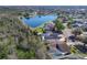 Aerial view of homes near a pond showing fenced yards and screened pools at 3123 Fairfield Dr, Kissimmee, FL 34743