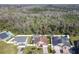 An aerial shot captures homes with pools in a community backing up to a forest at 3123 Fairfield Dr, Kissimmee, FL 34743