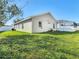 Exterior shot of the backyard showing lawn and screened in patio area at 3123 Fairfield Dr, Kissimmee, FL 34743