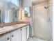 This bathroom features dual sinks with granite countertop and a shower at 3123 Fairfield Dr, Kissimmee, FL 34743
