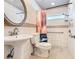This bathroom features a pedestal sink, white tile, and modern toilet at 3123 Fairfield Dr, Kissimmee, FL 34743