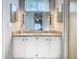 Double sink vanity in bathroom with large mirror and sconce lighting at 3123 Fairfield Dr, Kissimmee, FL 34743