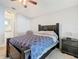 Bedroom features a ceiling fan and neutral decor with a view into the bathroom at 3123 Fairfield Dr, Kissimmee, FL 34743