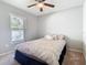 Cozy bedroom with a ceiling fan and window providing natural light at 3123 Fairfield Dr, Kissimmee, FL 34743