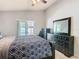 Bedroom showcases a large dresser, ceiling fan and sliding glass doors to the patio at 3123 Fairfield Dr, Kissimmee, FL 34743