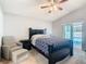 Bedroom with pool views, ceiling fan, and a cozy chair at 3123 Fairfield Dr, Kissimmee, FL 34743