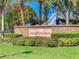 Entrance to Strafford Park featuring a brick sign, well-maintained landscaping, and a glimpse of neighborhood homes at 3123 Fairfield Dr, Kissimmee, FL 34743