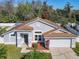 Landscaped home with a two-car garage, showcasing clean lines and a welcoming entrance at 3123 Fairfield Dr, Kissimmee, FL 34743