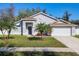 Charming single-story home with well-manicured lawn and tropical landscaping, creating curb appeal at 3123 Fairfield Dr, Kissimmee, FL 34743