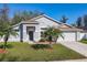Charming single-story home featuring a well-manicured front yard and lush landscaping in a bright setting at 3123 Fairfield Dr, Kissimmee, FL 34743