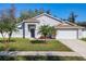 Charming single-story home with a well-manicured lawn and beautiful palm trees in a bright setting at 3123 Fairfield Dr, Kissimmee, FL 34743