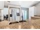 Bright kitchen featuring granite countertops and stainless steel refrigerator, next to dining room at 3123 Fairfield Dr, Kissimmee, FL 34743