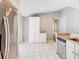 Well-lit kitchen features white cabinets, stainless steel appliances, and tile flooring at 3123 Fairfield Dr, Kissimmee, FL 34743