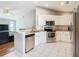 Modern kitchen featuring stainless steel appliances, sleek white cabinetry, and an efficient layout at 3123 Fairfield Dr, Kissimmee, FL 34743