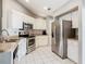 Well-equipped kitchen with white cabinetry, stainless steel appliances, and ample counter space at 3123 Fairfield Dr, Kissimmee, FL 34743