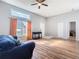 Spacious living room showcasing wood floors, ceiling fan, and sliding door leading to the exterior at 3123 Fairfield Dr, Kissimmee, FL 34743