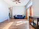 Bright living room boasts hardwood floors, high ceilings, and a cozy seating area with natural light at 3123 Fairfield Dr, Kissimmee, FL 34743