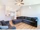 Comfortable living room featuring wood floors, ceiling fan, and an open concept that leads to the kitchen at 3123 Fairfield Dr, Kissimmee, FL 34743