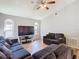 Comfortable living room with a ceiling fan, large TV, and plenty of seating space at 3123 Fairfield Dr, Kissimmee, FL 34743