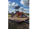 A colorful playground with slides, climbing structures, and a soft, woodchip surface at 3123 Fairfield Dr, Kissimmee, FL 34743