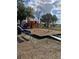 A playground in the community features play equipment and a bench at 3123 Fairfield Dr, Kissimmee, FL 34743