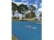 A painted shuffleboard court surrounded by trees offers an area for entertainment at 3123 Fairfield Dr, Kissimmee, FL 34743