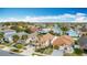 Enjoy an aerial view of this residential neighborhood with mature trees and landscaping on a sunny day at 3233 Brewster Dr, Kissimmee, FL 34743