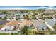 An aerial shot displays a tranquil suburban neighborhood, complete with a serene lake view and mature trees at 3233 Brewster Dr, Kissimmee, FL 34743