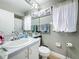Bathroom with shower/tub combo, decorative wall hangings, and neutral-colored walls at 3233 Brewster Dr, Kissimmee, FL 34743