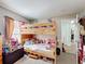 Bunk beds and lots of toys and stuffed animals are featured in this cute bedroom at 3233 Brewster Dr, Kissimmee, FL 34743