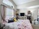 This bedroom features a large window and vaulted ceilings and neutral decor at 3233 Brewster Dr, Kissimmee, FL 34743