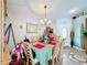 Inviting dining room with wooden table set for six, enhanced by natural light and decorative accents at 3233 Brewster Dr, Kissimmee, FL 34743