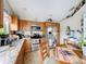 This kitchen is equipped with stainless steel appliances, granite countertops, and ample wooden cabinets at 3233 Brewster Dr, Kissimmee, FL 34743