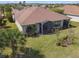 Aerial view of a well-kept backyard featuring a screened-in lanai and lush landscaping at 3384 Fallbrook Dr, Poinciana, FL 34759