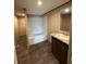 Well-lit bathroom features a granite countertop, oval sink, and a shower-tub combo at 34517 Laralack Ave, Leesburg, FL 34788