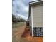 Home exterior featuring stone accents, vinyl siding, and landscaping at 34517 Laralack Ave, Leesburg, FL 34788