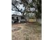 Exterior view of the home showcasing a cozy entrance with new stone and shutters at 34517 Laralack Ave, Leesburg, FL 34788
