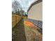 Exterior shot highlighting the home's vinyl siding and rock facade along the side of the home at 34517 Laralack Ave, Leesburg, FL 34788