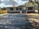 Charming home showcasing a paved driveway and stone siding at 34517 Laralack Ave, Leesburg, FL 34788