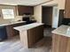 Gorgeous kitchen features a center island, stainless appliances and lots of storage at 34517 Laralack Ave, Leesburg, FL 34788