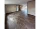 Open living room showcasing wood-look flooring, ample space, and recessed lighting at 34517 Laralack Ave, Leesburg, FL 34788