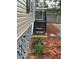 Side view of home with rock skirting, a stairway, and beautifully maintained landscape at 34517 Laralack Ave, Leesburg, FL 34788